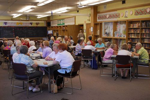 A room full of people playing cards