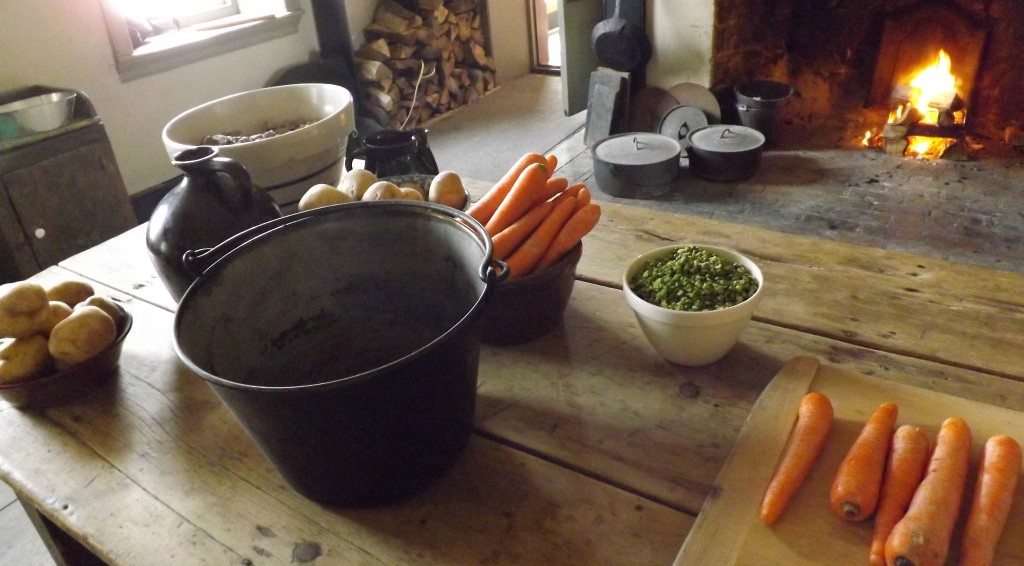 A farm table with vegetables and pots.