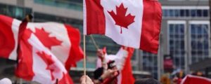 Canadian flags being held by people.