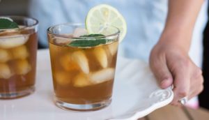 Glasses of iced tea on a serving tray.