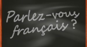 "Parlez-vous francais?" written on a blackboard.