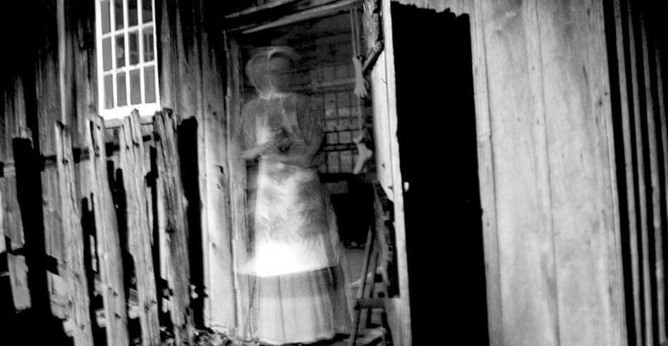 An eerie-looking ghost in a doorway.