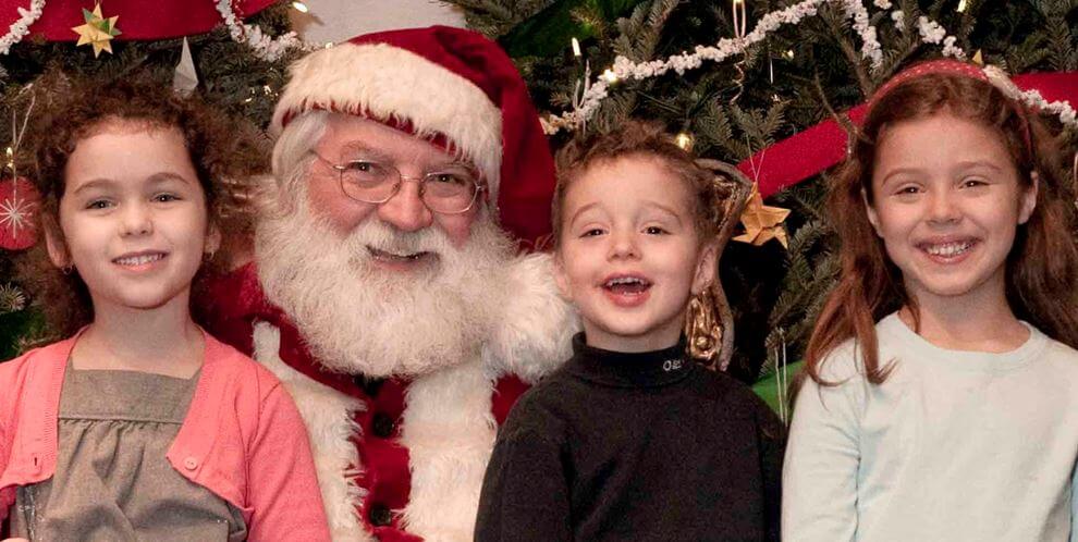 Santa and three happy kids.
