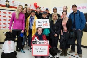 A group of people posing with a 'We will end MS' sign.