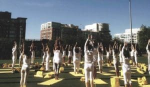 An outdoor Moksha yoga class.