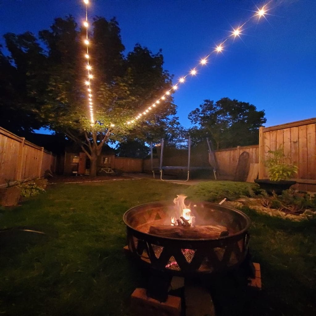 64 Burlington St - Backyard at night with fire pit and string lights