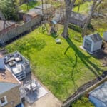 drone photo of wide, treed backyard at 10 woodbury place