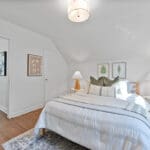 10 woodbury place primary bedroom and upper landing with hardwood floors