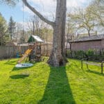 backyard with mature trees and massive lawn at 10 woodbury place