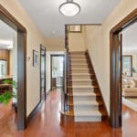 Wood staircase with original iron railing at 1370 Islington Avenue