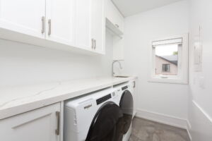 Convenient second-floor laundry room at 28 Martin Grove Road, thoughtfully positioned near the home's four upper-level bedrooms