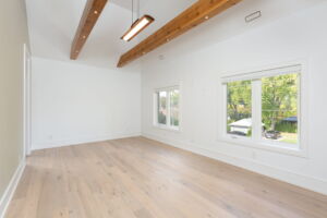 Exceptional primary bedroom at 28 Martin Grove Road featuring cathedral ceilings reaching approximately 14 feet and exposed timber beams