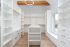 Custom-designed dressing room with centre island, statement lighting and beautifully organized storage at 28 Martin Grove Road