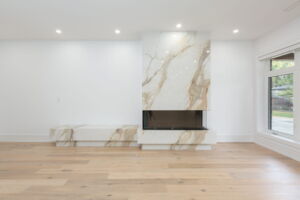 Floor-to-ceiling fireplace feature wall in Etobicoke home at28 Martin Grove Road