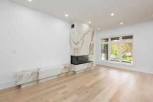 Contemporary living room with three-sided fireplace at28 Martin Grove Road