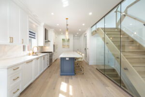 Open-concept kitchen and dining area with wide-plank hardwood floors and contemporary finishes in Islington-City Centre home at 28 Martin Grove Road