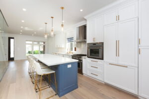 Bright custom kitchen with integrated refrigerator, wall oven and extensive cabinetry at 28 Martin Grove Road in Etobicoke