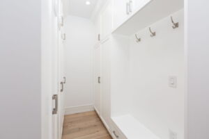 Custom family mudroom with coat hooks, shoe storage and extensive cabinetry connecting the home to its oversized garage- 28 Martin Grove Road Etobicoke Real Estate