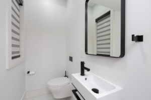 Contemporary main-floor powder room at 28 Martin Grove Road featuring modern fixtures and beautifully coordinated finishes at 28 Martin Grove Road Etobicoke Luxury Home