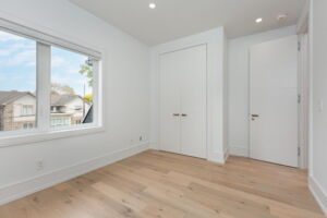 Bright fourth bedroom with contemporary finishes and generous built-in closet space at 28 Martin Grove Road