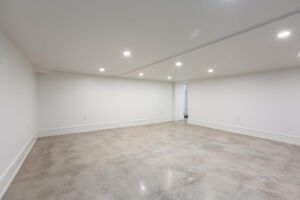 Versatile lower-level flex room at 28 Martin Grove Road featuring polished concrete floors and contemporary finishes