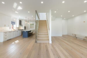 Bright foyer with custom staircase and glass railings at28 Martin Grove Road