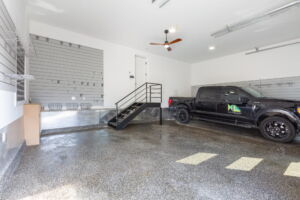 Finished garage with high ceilings, contemporary flooring and custom storage solutions at this rebuilt Etobicoke residence at28 Martin Grove Road