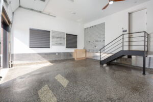 Oversized attached garage at 28 Martin Grove Road featuring high ceilings, finished flooring and extensive organized storage